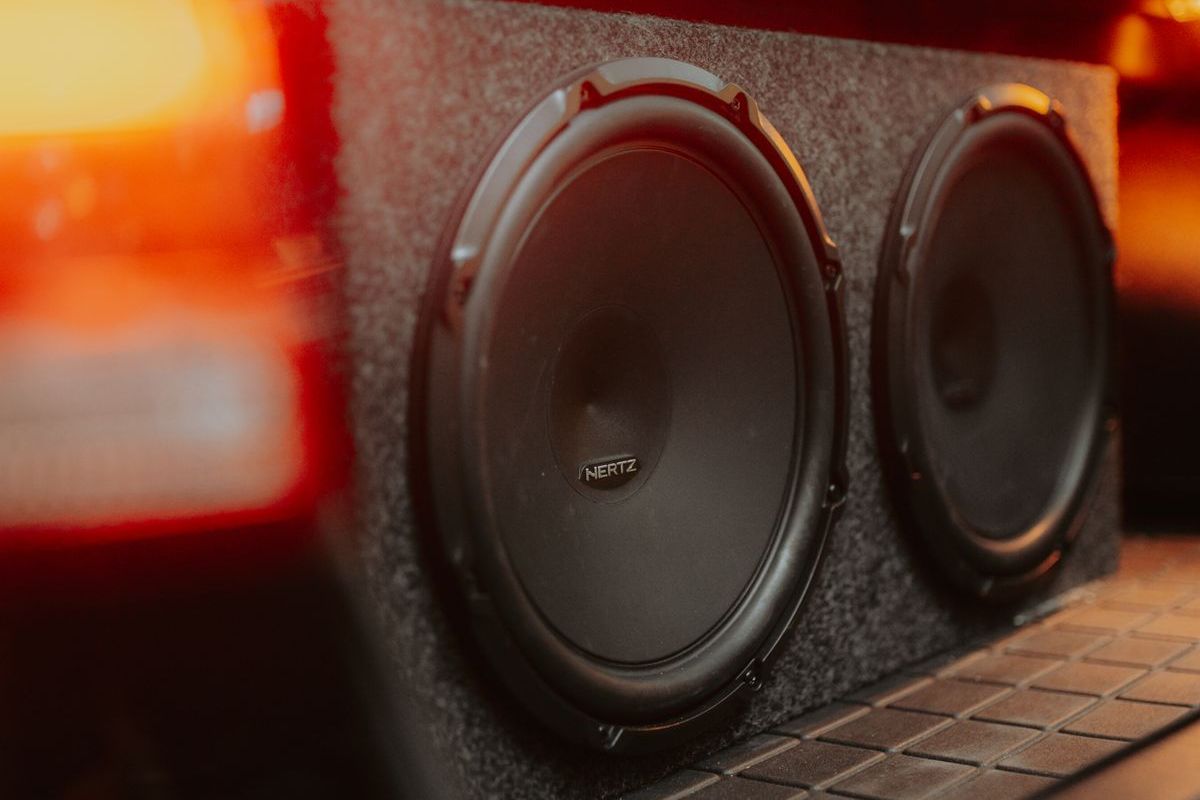A pair of subwoofers mounted in a vehicle enclosure