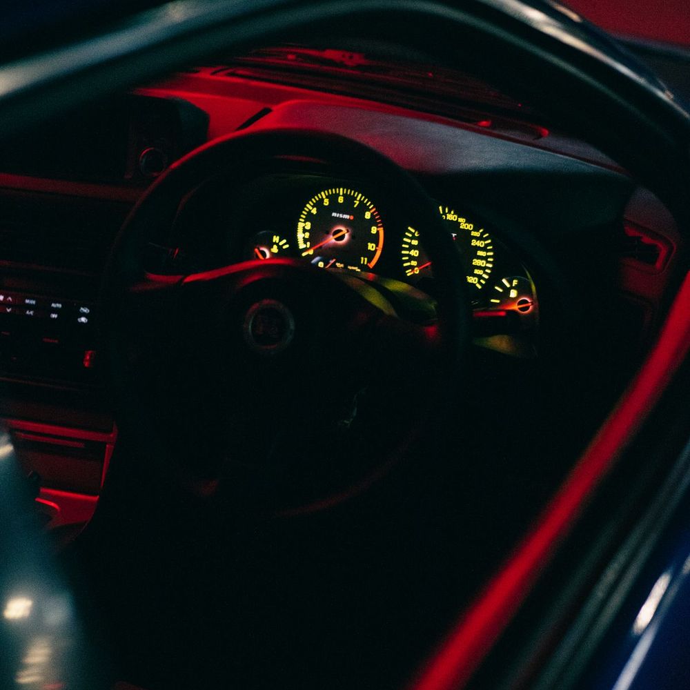 A car interior lit at night